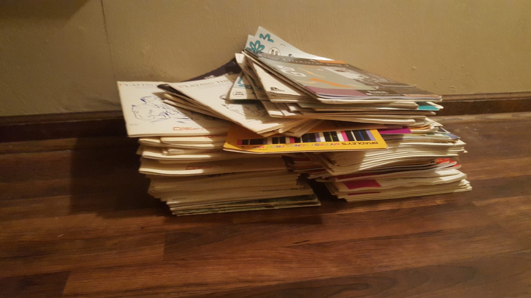 Stacks of donated sheet music and music education books prepared for Happy Life in Kenya during the 2018 mission.