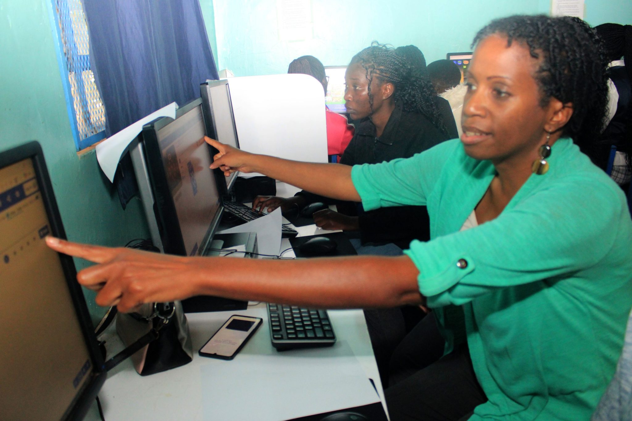 Kennesha demonstrating a digital lesson in the Grace Harvest Academy computer lab