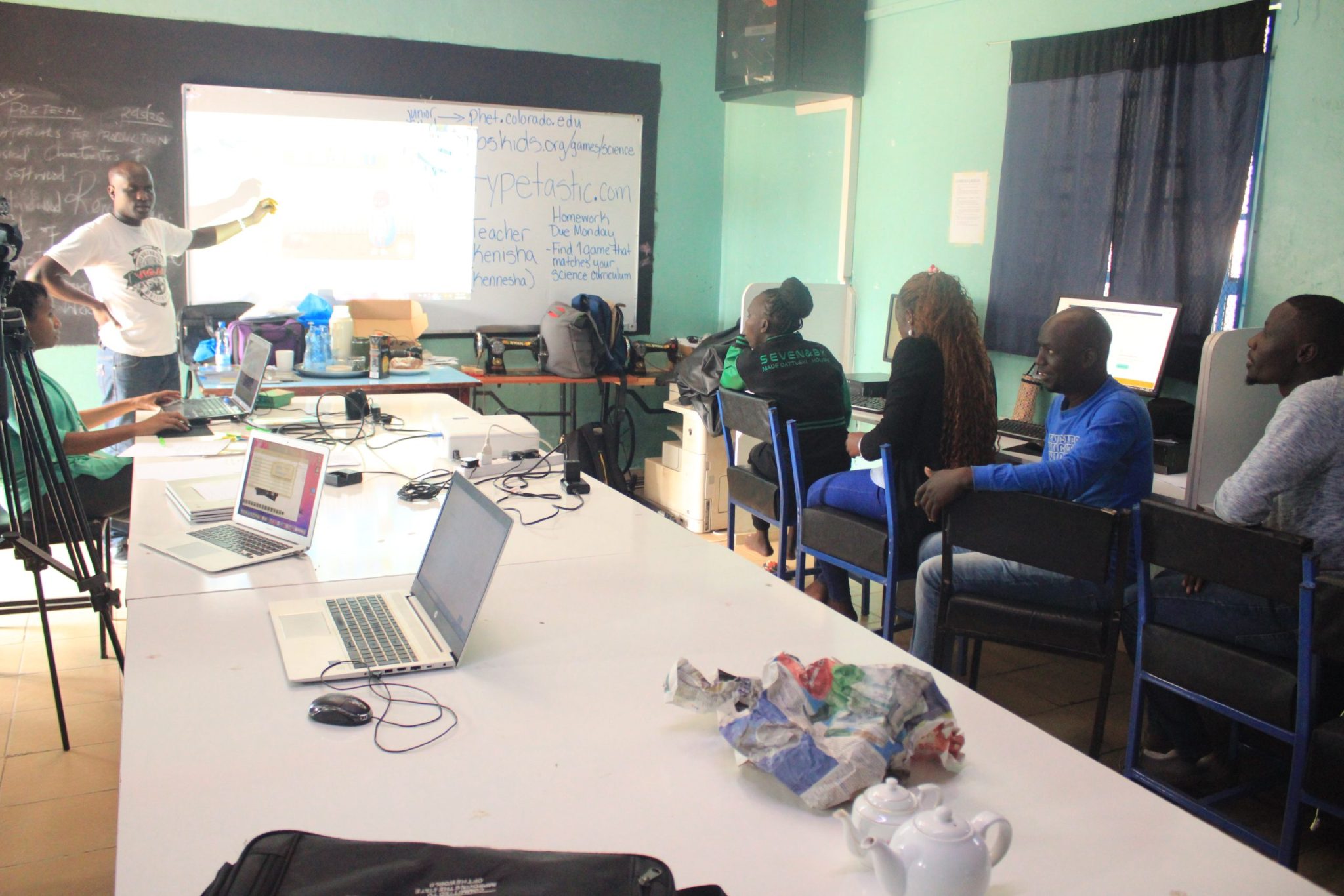 Computer training session with instructor and participants at Grace Harvest Academy