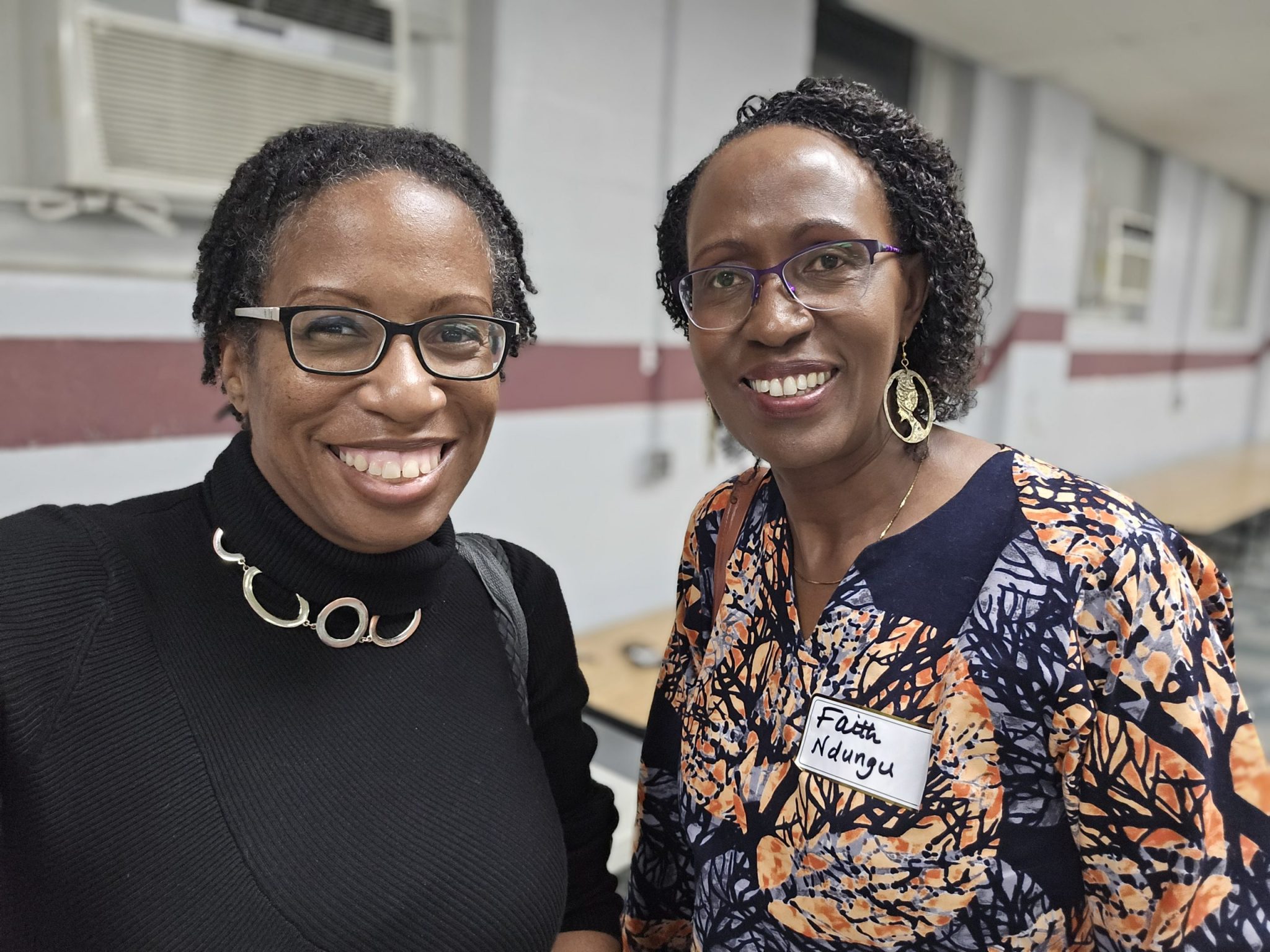 Kennesha and Pastor Faith smiling together at a Happy Life Mission-Kenya gathering.