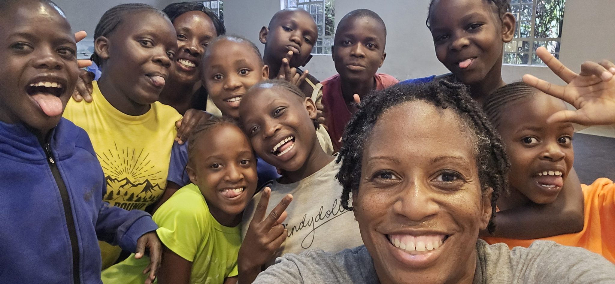 Smiling students gathering for a group selfie at Happy Life in Juja Farm.
