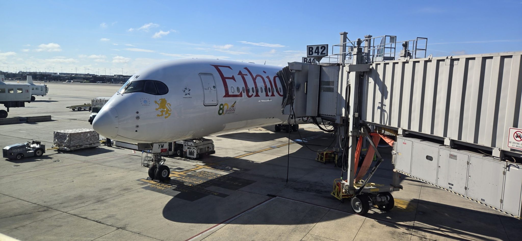 Ethiopian Airlines aircraft parked at an airport gate with a jet bridge attached.